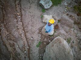 Top view of African American engineer at the construction site wearing hard hat and goggles photo