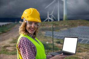 Female engineer use her laptop while working in solar power plant, screen with mockup photo