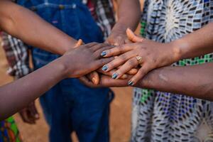 Hands of African people on top of each other, concept of unity. photo