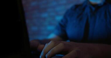 Man using a laptop computer in a dark room video