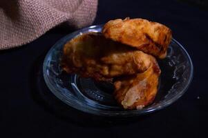 Godo is a typical Indonesian snack which is usually made from bananas, sweet potatoes or jackfruit which are sprinkled with flour and sugar, then fried until yellow. photo