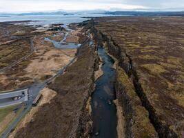Aerial panorama of Oxarafoss waterfalls in Thingvellir National Park, Iceland, featuring the scenic Oxara River and the unique landscape created by the tectonic plates of America and Eurasia. photo