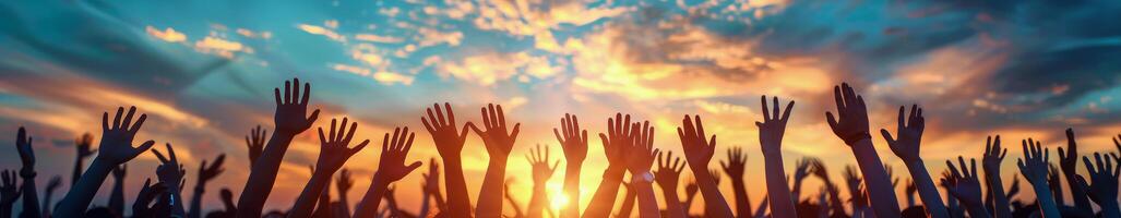 Silhouette of Raised Hands During a Sunset Concert photo