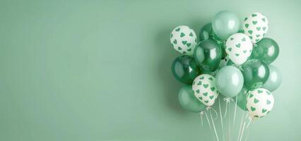 Green Balloons With Shamrock Patterns Against A Green Wall photo