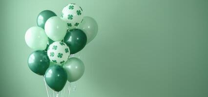 Green Balloons With Shamrock Patterns Against A Green Wall photo