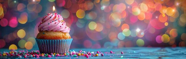 Single Birthday Cupcake With Candle Against Bokeh Lights photo