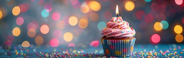 Single Birthday Cupcake With Candle Against Bokeh Lights photo