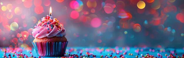 Single Birthday Cupcake With Candle Against Bokeh Lights photo