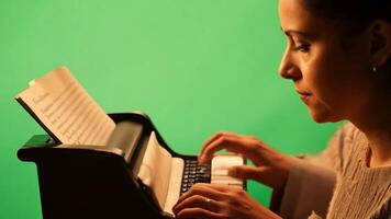 A novelist in casual attire, typing on a typewriter. Green screen backdrop. Warm, soft lighting to evoke a creative atmosphere. video