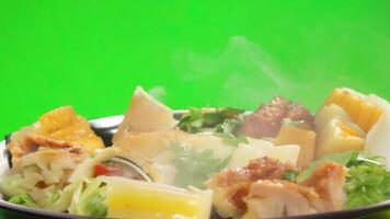A platter of assorted dim sum with steam rising. Green screen backdrop. Bright, even lighting to highlight the variety. video