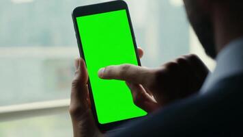 A Man with green screen chroma key smartphone on blurred background video