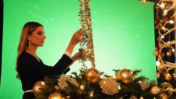 An event planner in stylish attire, setting up decorations. Green screen backdrop. Warm, soft lighting to create a festive feel. video