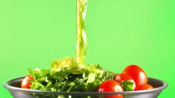 A vibrant salad with mixed greens, cherry tomatoes, cucumbers, and a drizzle of dressing. Green screen backdrop video