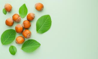 Hazelnuts with Shells and Green Leaves Flat Lay with Copy Space photo