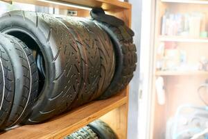 Scooter tires stacked on a shelf in a repair shop store photo