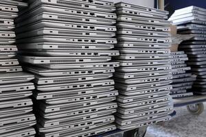 Big stacks of discarded laptops, notebooks on a trolley photo