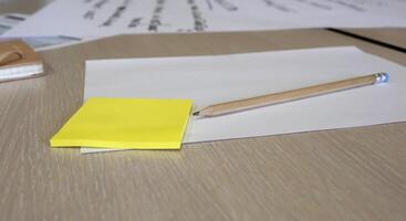 Post it notes, papers and a pencil during a brainstorming session at a business workshop photo