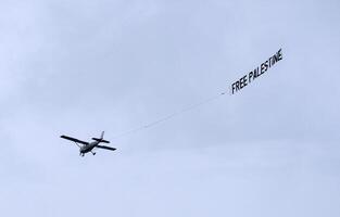 A plane with a Free Palestine banner in the sky photo