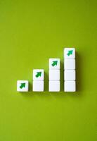 Growing graph made of blocks and up arrows. Steps of growth. Enlargement and growth concept. Career, economics. Statistics and news. Skills and self-development. photo