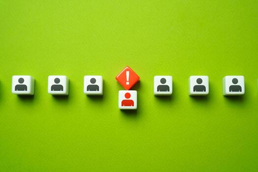 A man brought out of the line by an exclamation mark. Warning a person about violation of discipline. The worker is distrustful. Accusation of a crime or violation. Expulsion and dismissal. photo