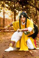 Tangerang, Indonesia - June 30 2024 Striking image of a young man in vibrant traditional Chinese costume, captured in an intense martial arts stance photo