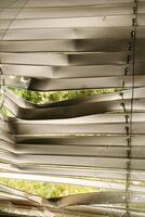 Damaged Window Blinds with Broken Glass in the abandoned house. Lost abandoned, decayed place. Abstract background. Window frame needs repair. photo