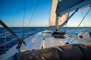 Yacht sailing in an open sea. Close-up view of the deck, mast and sails. Yachting concept. High quality photo