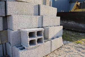 Structural blocks of strings on the mountain slopes on the excavator. Structural materials on the line photo