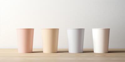 Four Paper Coffee Cups In Pastel Color Arranged On Wooden Table. Biodegradable Cup Collection. photo