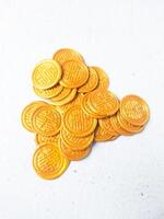 set of colorful wax coins on wooden background photo