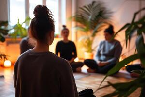 yoga instructor leading group of women in meditation class or therapy session in cozy room photo