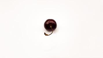 Fresh red cherry fruits on a plate on a white background in close-up. High quality photos