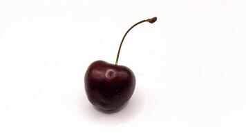Fresh red cherry fruits on a plate on a white background in close-up. High quality photos