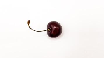 Fresh red cherry fruits on a plate on a white background in close-up. High quality photos