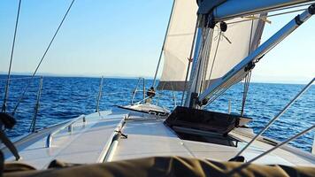 Yacht sailing in an open sea. Close-up view of the deck, mast and sails. Yachting concept. High quality 4k footage video