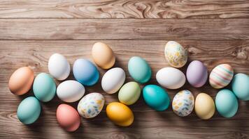 Top view Easter decorative scene adorned colorful pastel eggs with patterned on wooden table backdrop with free space for creative design photo
