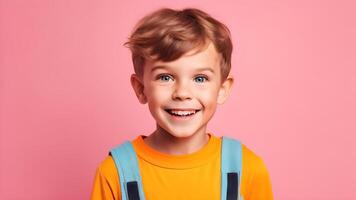 Portrait of smiling little boy wear yellow t-shirt nice looking attractive sweet lovely cheerful curious smart clever kid posting on pink pastel background photo