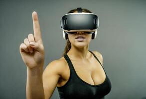 Young Woman Using VR Headset Pointing Upward photo