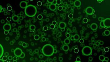 Abstract organic space with glow green cells floating on a dark background. Round shapes with close up effect. Illuminated bright spheres animation for chemistry, biology and other science. 4K 60fps video