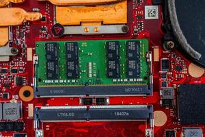 a motherboard with intricate circuit patterns, RAM modules, and various electronic components photo
