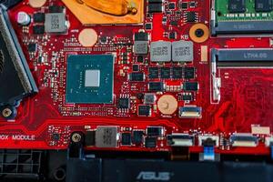 a motherboard with intricate circuit patterns, RAM modules, and various electronic components photo