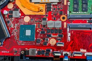 a motherboard with intricate circuit patterns, RAM modules, and various electronic components photo