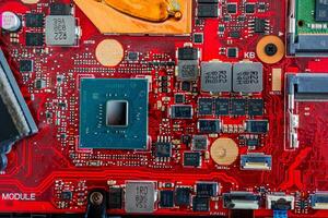 a motherboard with intricate circuit patterns, RAM modules, and various electronic components photo
