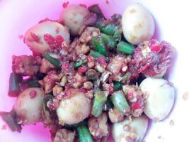 a bowl of balado quail eggs and tempeh ready to eat isolate on white photo