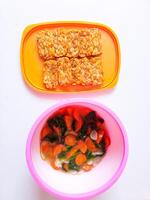 Fried tempeh and a bowl of spinach and carrots are ready to eat photo
