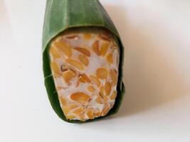 tempeh wrapped in banana leaves isolate on white photo