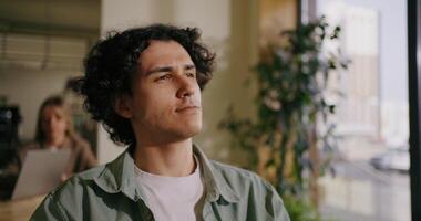 Portrait Of Mixed Race Man Sitting In Cafe, Thinking And Messaging In Mobile App, Internet Addiction video