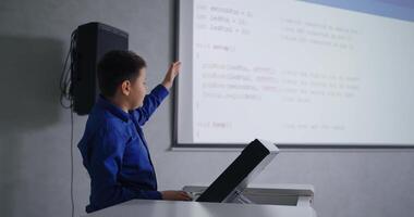 School Student Boy Speaking In Front Of Classmates In Classroom, Presenting His Program Code video
