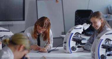 Education In Modern Classrooms, Young Students Of Middle School Using Microscopes In Classes video