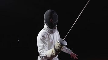 Fencer Fighting With Rival, Portrait In Motion In Black Background, Slow Motion Shot video